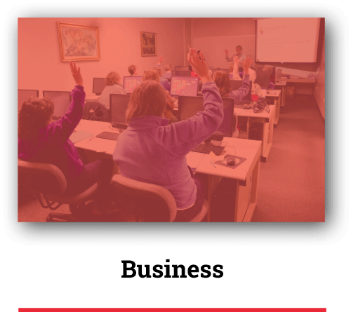 students raising their hands in classroom with computers with red overlay